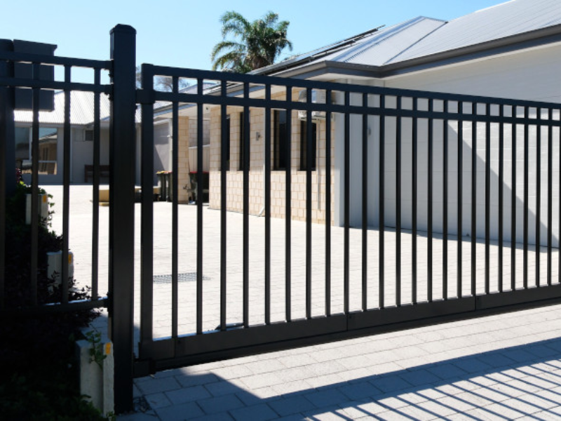 Technician connecting access control wiring to sliding gate system