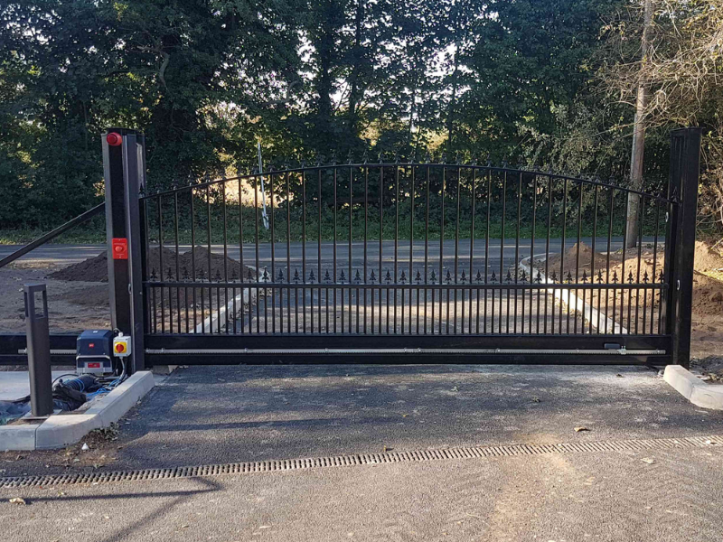 Modern home driveway with automated sliding gate system