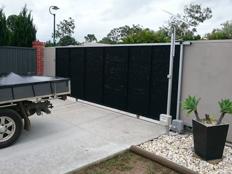 Clean, renewable energy powers this solar sliding gate automation setup in a suburban home.