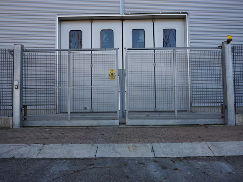 Secure sliding gates for warehouses powered by a heavy-duty industrial sliding gate motor system