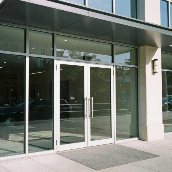Technician installing automatic swing door opener with correct alignment
