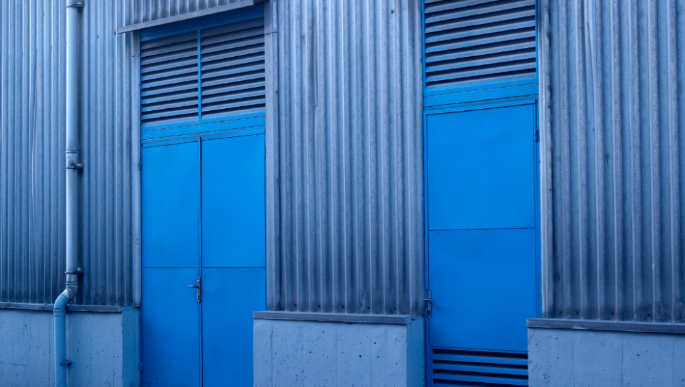 Vision Z-Wave Outdoor Siren mounted on factory exterior wall - industrial alarm siren