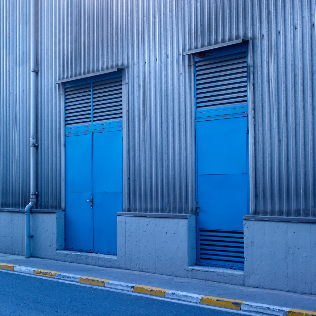 Vision Z-Wave Outdoor Siren mounted on factory exterior wall - industrial alarm siren