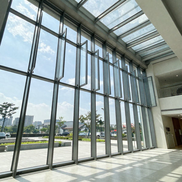 Smart window control system operating automated windows in large glass atrium building.